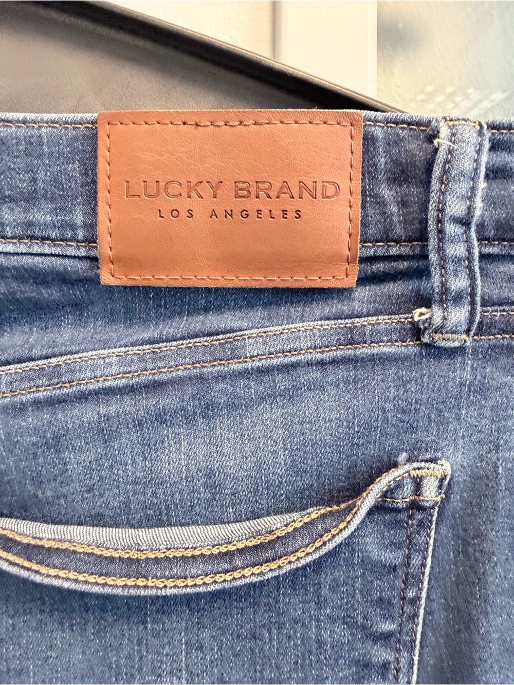 Lucky Brand womans Medium Blue Slim Jeans with Brown Leather Patch